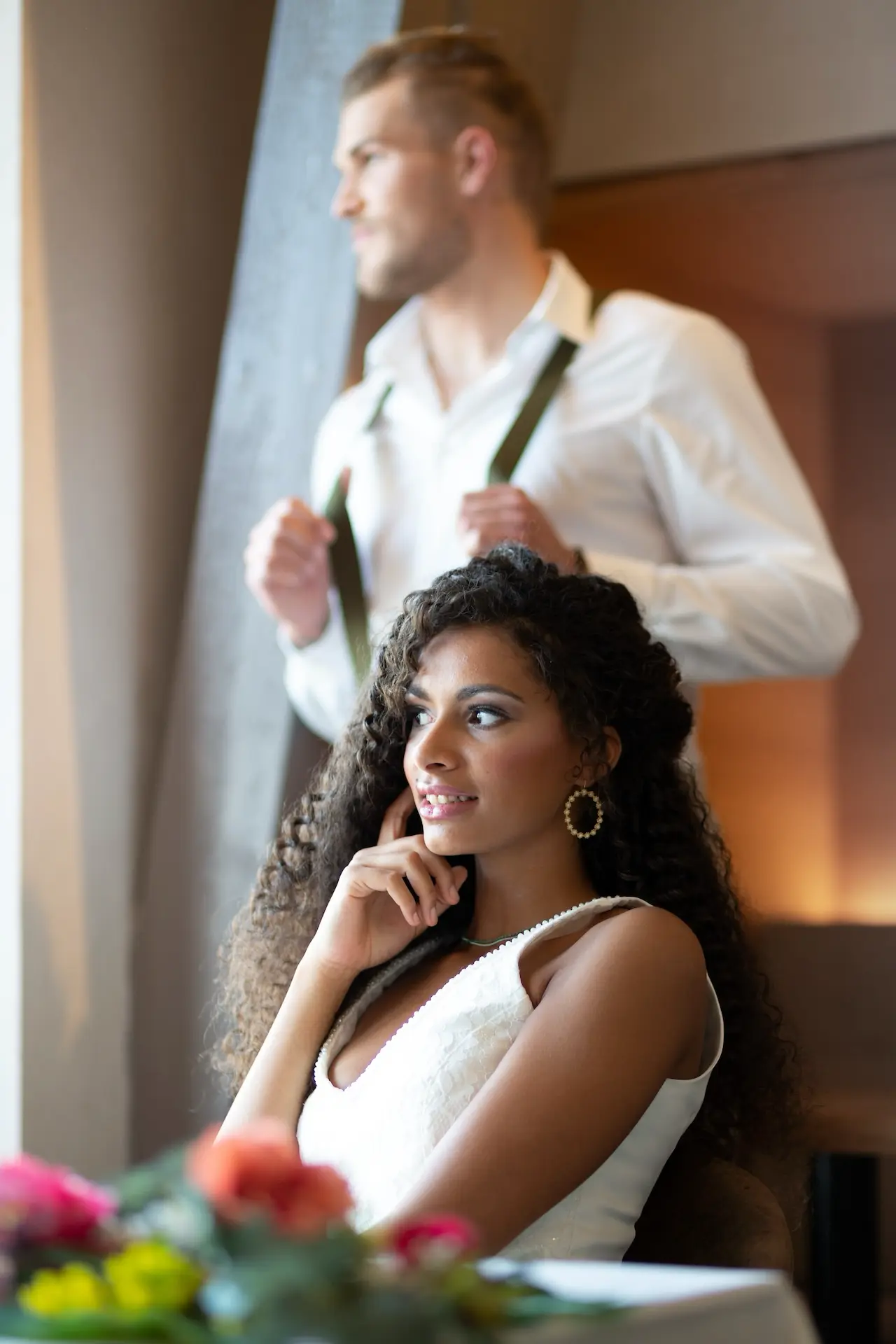 a man and woman looking out a window